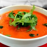 Tomato Gazpacho soup in a white bowl.