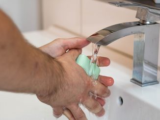 Washing hands with soap and water under a tap (faucet). A way to alleviate the spread of cold and flu virus.