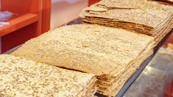Traditional Iranian Sangak Bread topped with sesame seeds and sunflower seeds. Widespread type of Persian bread.