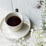 coffee americano in white cup on white table with white spray.