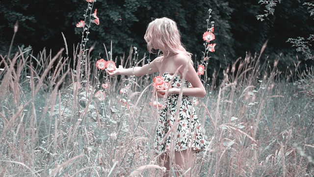Girl collecting flowers in a meadow.
