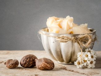 Cup of shea butter with shea nuts