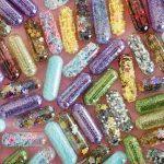 Capsules in coloured forms on a table.. Will contain microencapsulated ingredients.