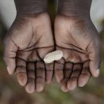 African child cupped hands holding some peanut. malnutrition - a scourge of the world.