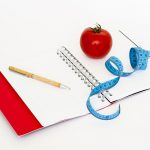 Notebook, apple, measuring tape and pencil. Images used to support various diets including Atkins Diet, the Slimfast diet