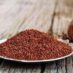 Finger Millet / Red Millet close up selective focus on wooden background. Known in India as ragi.