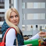 Consumer paying for food and beverage goods at a counter in a shop. Shopping behaviour.