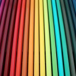 Pencils lined up according to the colour spectrum.