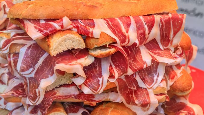 Bocadillo - piles of serrano ham inside a baguette.