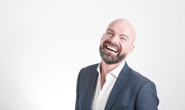 Bald man with beard. Does not give a toss about hair loss. Seems really happy !