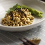 Natto in a white bowl with asparagus.