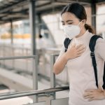 Woman wearing a mask hoping to prevent droplet infection by a virus like a coronavirus.