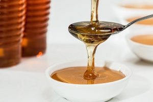 Honey pouring from a spoon. A way to alleviate symptoms of cold and flu.