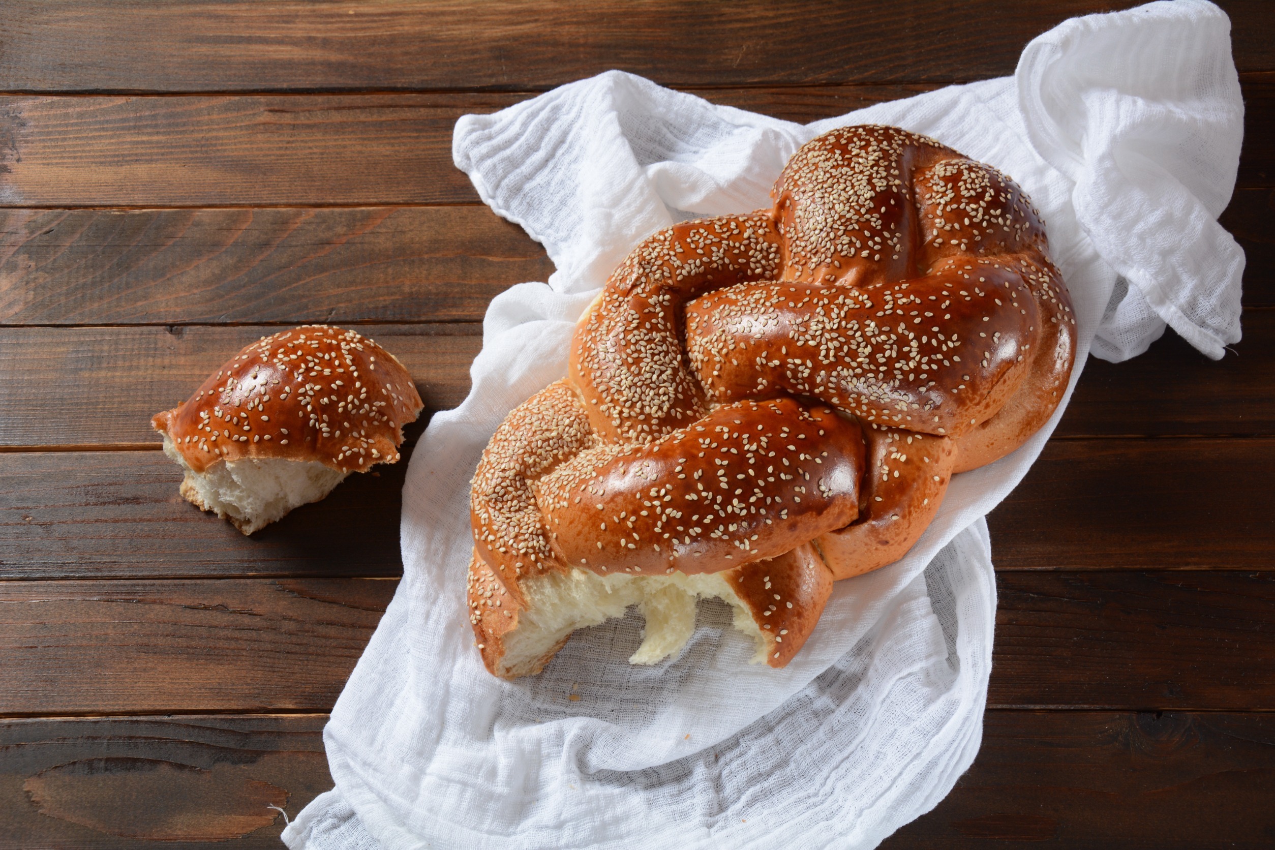 Homemade challah bread with sesame seeds. Jewish traditional bread for Shabbat