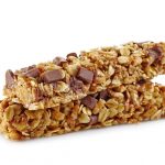 Granola bars with peanut butter and chocolate on white background