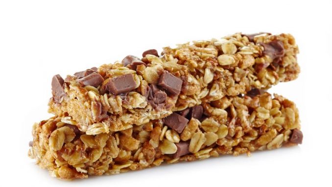 Granola bars with peanut butter and chocolate on white background