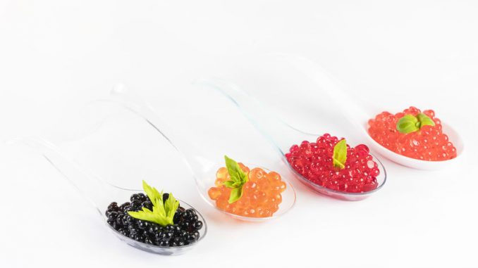 An example of molecular gastronomy. Caviar on four different spoons.
