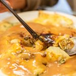 woman eat traditional Taiwanese snack of oyster omelette.
