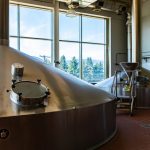 Mash lauter tun used for mashing and lautering, two stainless steel big vessels, Brewing tank top with glass manway door, Modern brewhouse, brewery room in big beer factory machines