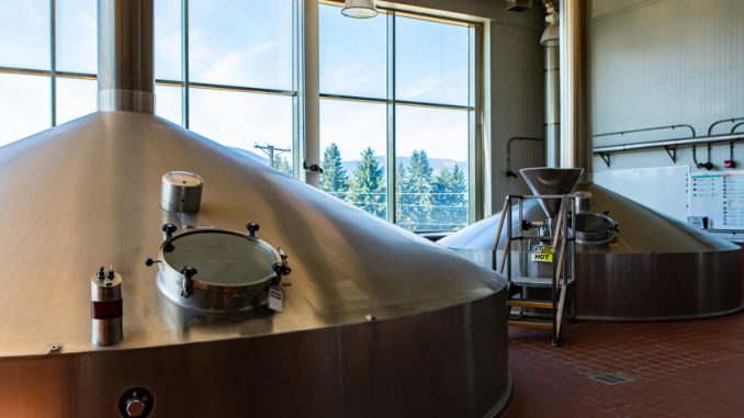 Mash lauter tun used for mashing and lautering, two stainless steel big vessels, Brewing tank top with glass manway door, Modern brewhouse, brewery room in big beer factory machines
