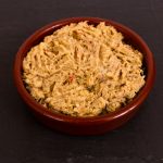 Homemade smoked mackerel pate in a ceramic disk on a slate background.