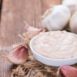 Portion of fresh homemade Aioli dip on wooden background