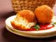 Deep fried balls of arborio rice stuffed with mozzarella cheese to make arancini