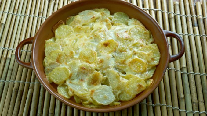 Pommes Anna classic French dish of sliced, layered potatoes cooked in a very large amount of melted butter.