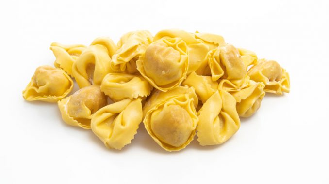 Italian traditional tortellini pasta isolated on white background.. The shape needed for a mushroom duxelle filled tortellini.