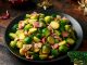 Christmas Brussel Sprouts and Bacon with decoration, gifts, green tree branch on wooden rustic table.