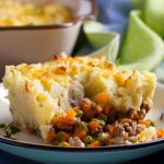 Cottage Pie on plate, gray backgroud. Horizontal image