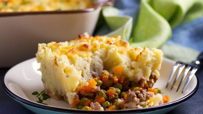 Cottage Pie on plate, gray backgroud. Horizontal image