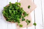 Fresh Watercress on white table background.