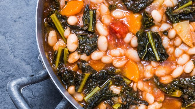 Soup with vegetables, beans, kale, top view.Typical tuscan bean soup, ribollita.