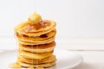 buttermilk pancakes stacked with butter and honey topping