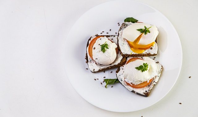 Perfect poached eggs on a slice of tomato and toast.