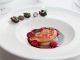 Foie gras with port sauce on white plate, haute cuisine, close-up, toned