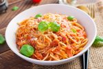 Spaghetti alla Amatriciana with guanciale, tomatoes and pecorino cheese. Italian healthy food.
