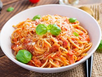Spaghetti alla Amatriciana with guanciale, tomatoes and pecorino cheese. Italian healthy food.