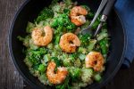 roasted garlic broccoli quinoa salad with prawns on pan