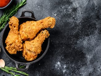 Spicy Deep Fried Breaded Chicken drumsticks. Black background. Top view. Copy space.