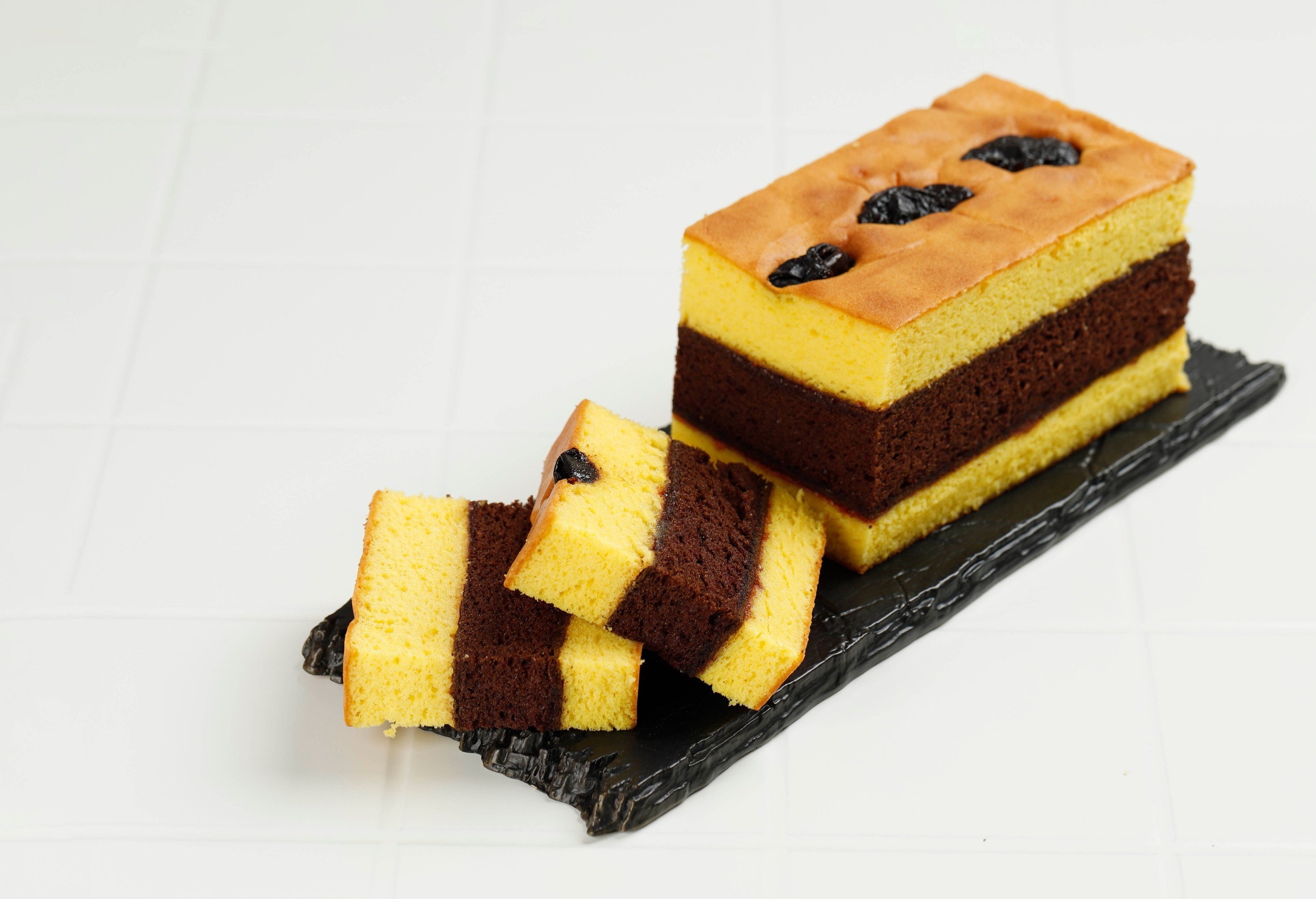Lapis Surabaya or Spiku, Indonesian Three Layer Cake with Strawberry Jam Between the Layer. Topped with Prunes.