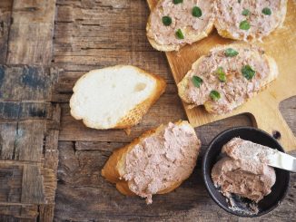Brussels pate. A liver pate on french bread on a wooden table