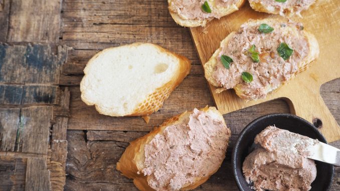 Brussels pate. A liver pate on french bread on a wooden table