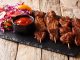 Nigerian barbecue: suya on skewers with fresh vegetable salad and ketchup close-up on the table. horizontal