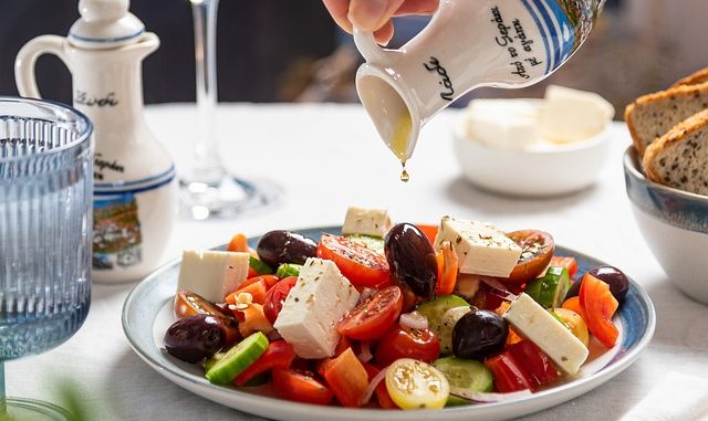 Greek Salad with olive oil drizzled over it.