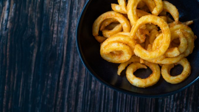curly fries on a dark background.