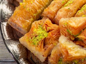 Delicious baklava dessert in oriental bronze setting close up. An example of sweets from Arabian countries.