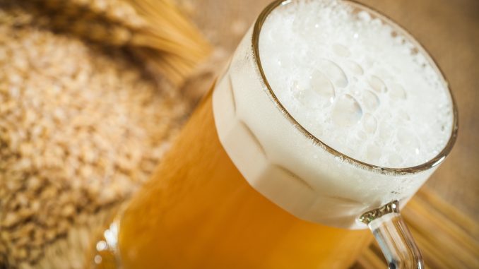 wheat beer with wheat ears on a table