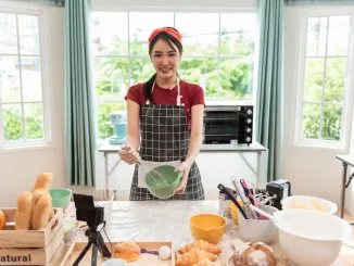 Happy woman use fresh natural products flour milk eggs kneading dough for pastries cookies by hands at modern kitchen. Polyphenols in baked products.